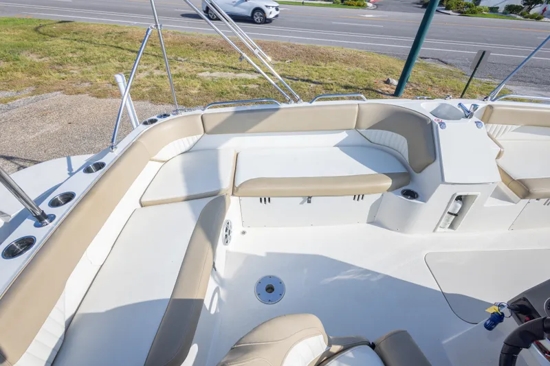 Slide: The Image of 2018 Stingray 192 SC boat interior with beige seating and cup holders. - 37