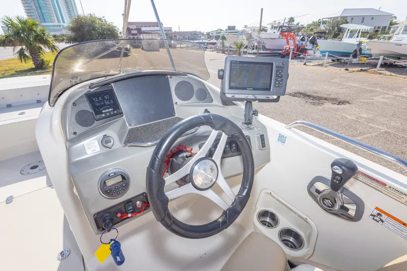 Slide: The Image of 2018 Stingray 192 SC boat dashboard with steering wheel and navigation system. - 25