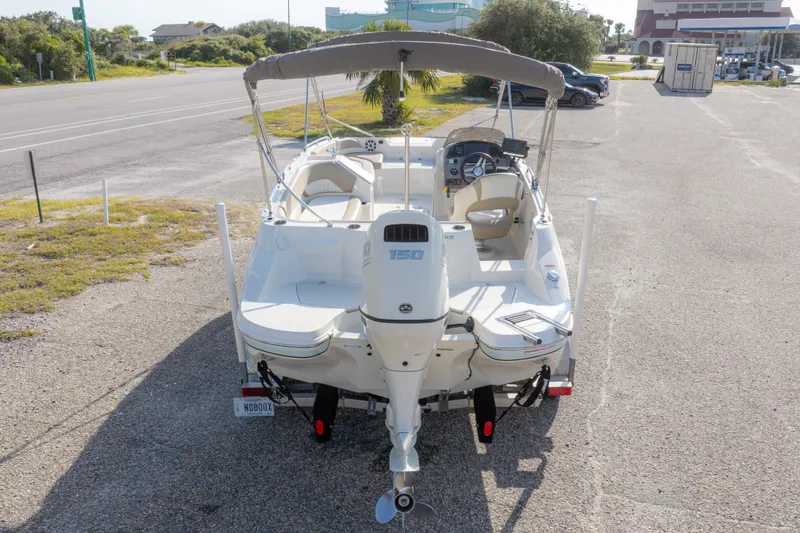 Slide: The Image of 2018 Stingray 192 SC boat with outboard motor, parked on a sunny day. - 47