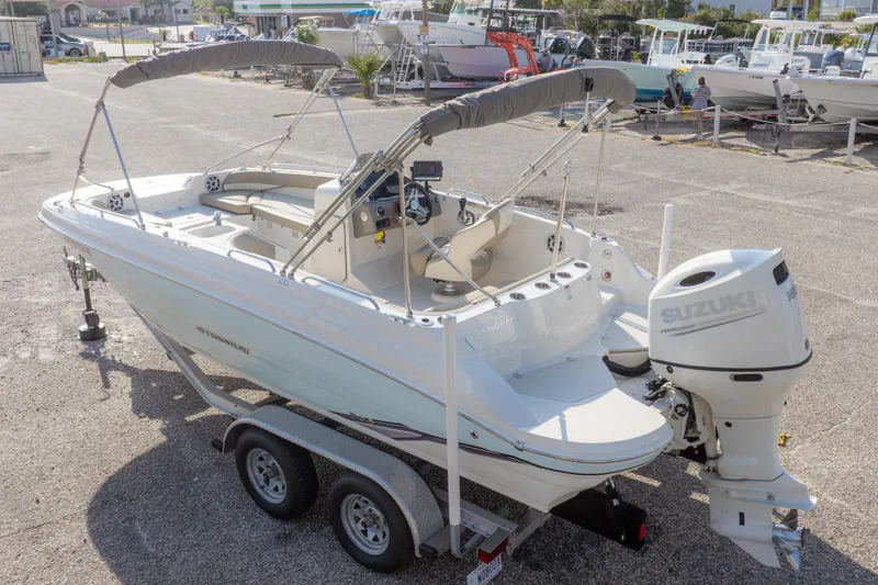 Slide: The Image of 2018 Stingray 192 SC boat with Suzuki outboard motor on a trailer. - 48