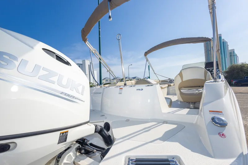 Slide: The Image of 2018 Stingray 192 SC boat with Suzuki engine, parked under clear blue sky. - 43