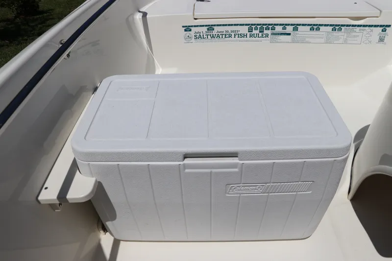 Slide: The Image of White Coleman cooler on 2017 Boston Whaler 130 Super Sport boat deck. - 17