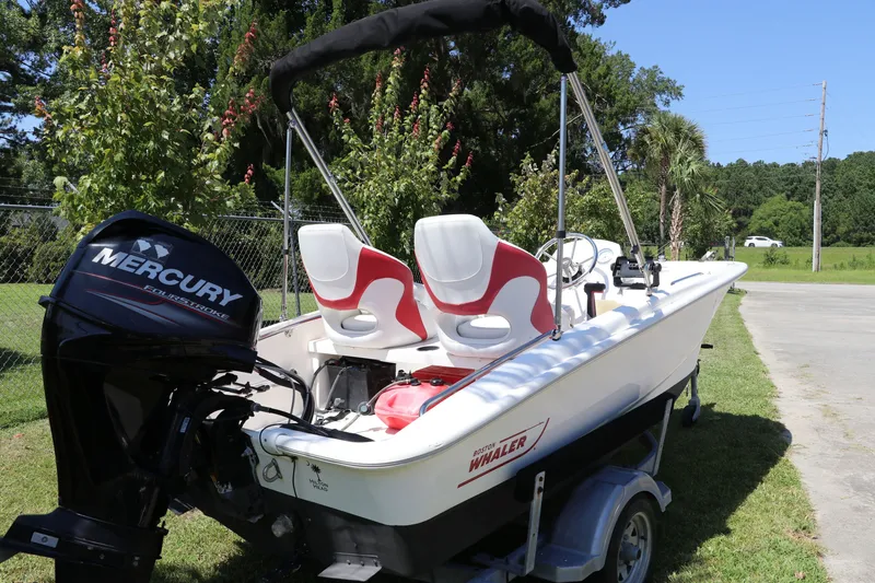 Slide: The Image of 2017 Boston Whaler 130 Super Sport boat with Mercury engine on trailer. - 7