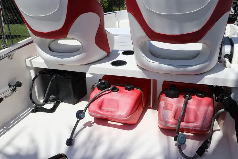 Slide: The Image of 2017 Boston Whaler 130 Super Sport boat interior with red fuel tanks and seating. - 11