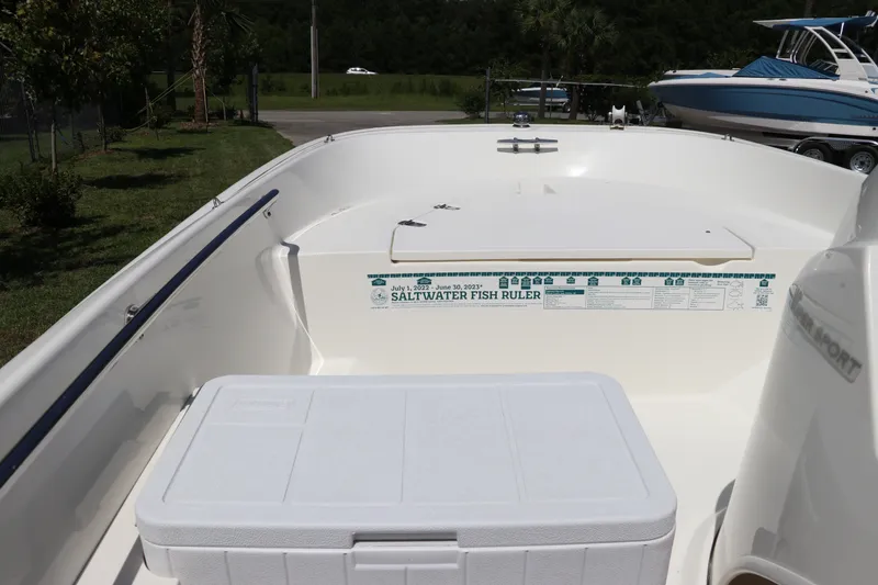 Slide: The Image of 2017 Boston Whaler 130 Super Sport interior with cooler and saltwater fish ruler. - 18