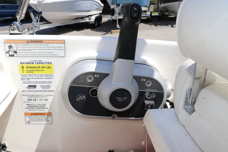 Slide: The Image of Control panel of a 2017 Boston Whaler 130 Super Sport boat with capacity warnings. - 16