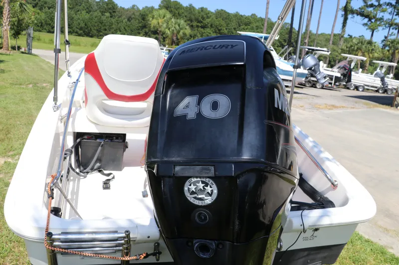 Slide: The Image of 2017 Boston Whaler 130 Super Sport with Mercury 40 engine, parked outdoors. - 6