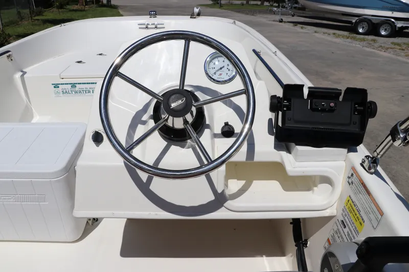 Slide: The Image of The image shows the helm of a 2017 Boston Whaler 130 Super Sport. - 15