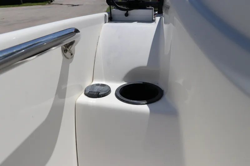 Slide: The Image of 2017 Boston Whaler 130 Super Sport boat interior detail with cup holder and railing. - 20
