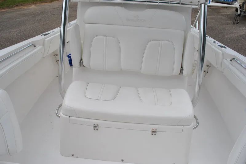 Slide: The Image of 2016 Regulator 28 Forward Seating boat with white cushioned seats and stainless steel accents. - 28