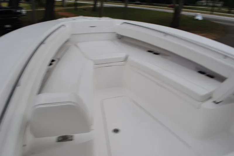 Slide: The Image of 2016 Regulator 28 Forward Seating boat interior with spacious white seating area. - 24