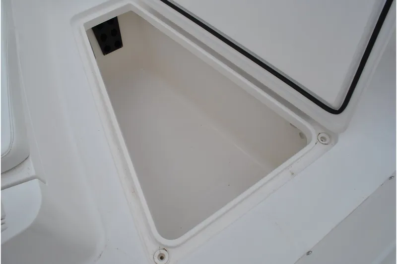 Slide: The Image of Open storage compartment on a 2016 Regulator 28 Forward Seating boat. - 27