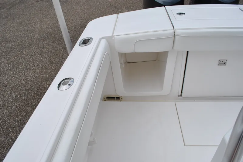 Slide: The Image of 2016 Regulator 28 Forward Seating boat interior with white cushioned seating and storage compartments. - 43