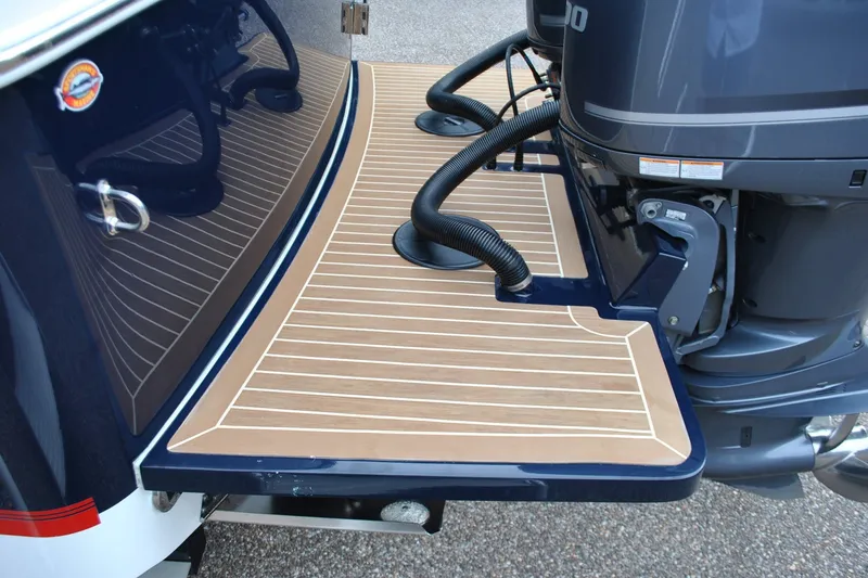 Slide: The Image of 2016 Regulator 28 Forward Seating boat with teak-style swim platform and dual outboard motors. - 46