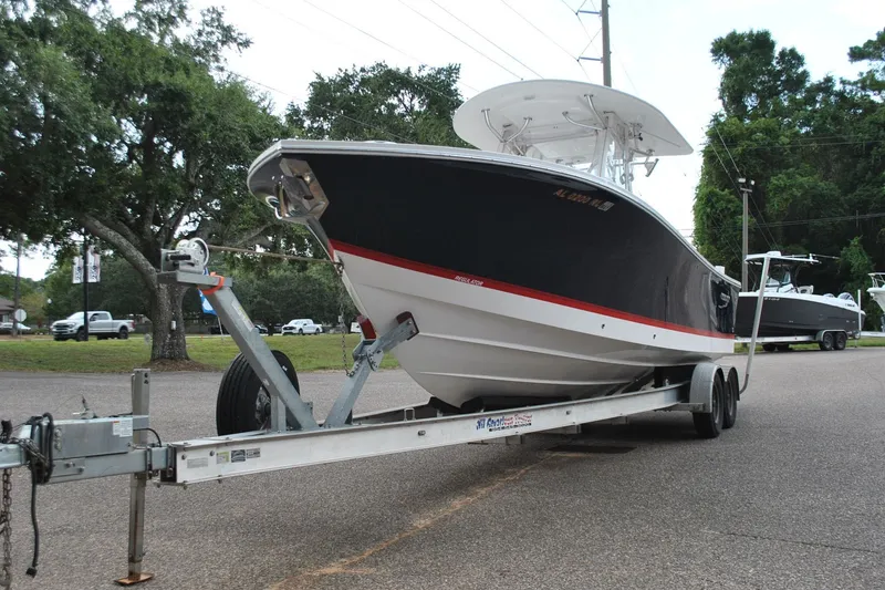 Slide: The Image of 2016 Regulator 28 Forward Seating boat on trailer, parked outdoors. - 3