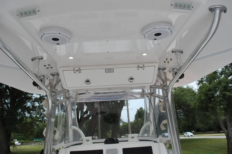 Slide: The Image of 2016 Regulator 28 Forward Seating boat interior with speakers and storage compartment. - 39