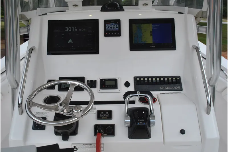 Slide: The Image of Control panel of a 2016 Regulator 28 Forward Seating boat with navigation screens. - 19