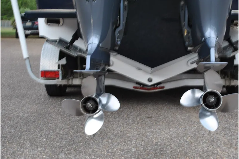 Slide: The Image of Twin propellers of a 2016 Regulator 28 Forward Seating boat on a trailer. - 11