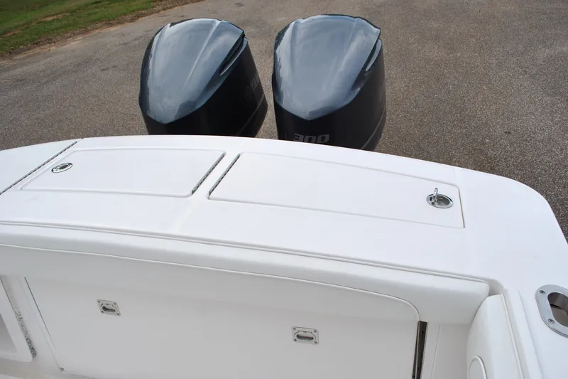 Slide: The Image of 2016 Regulator 28 Forward Seating boat with dual outboard engines. - 32