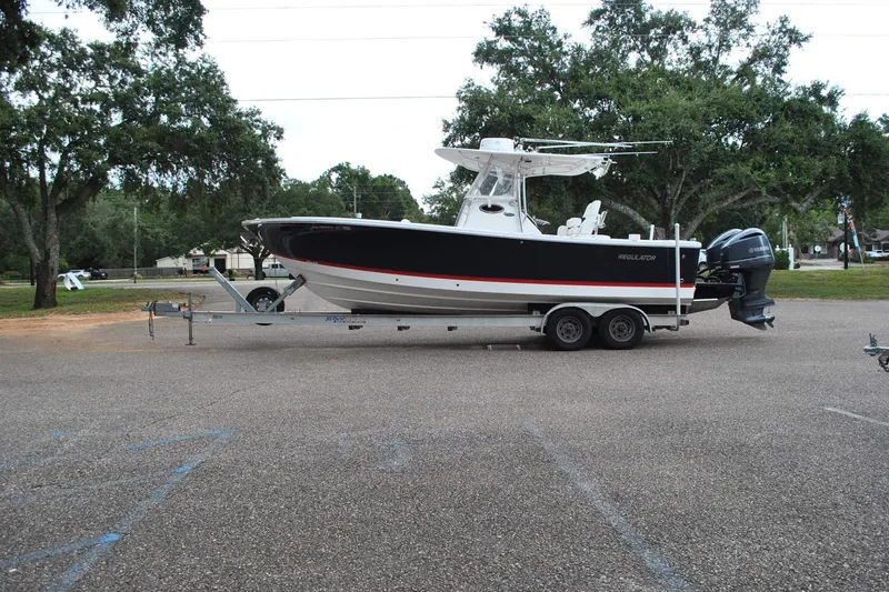 The Image of 2016 Regulator 28 Forward Seating boat on trailer in parking lot. - 1