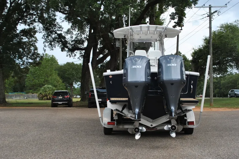 Slide: The Image of 2016 Regulator 28 Forward Seating boat with dual Yamaha 300 engines on a trailer. - 10