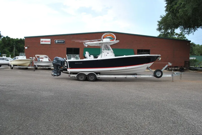 Slide: The Image of 2016 Regulator 28 Forward Seating boat on trailer outside dealership. - 6