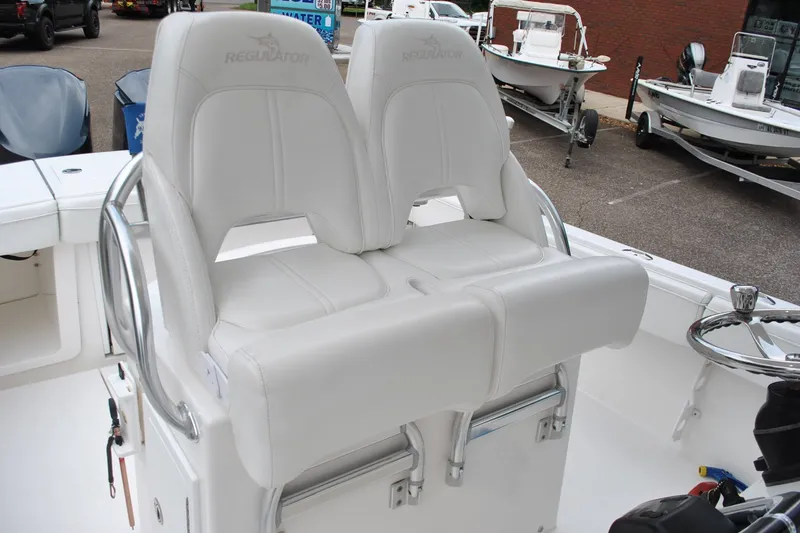 Slide: The Image of 2016 Regulator 28 Forward Seating boat with dual white captain's chairs. - 42