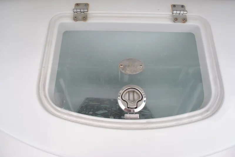 Slide: The Image of Hinged hatch on 2016 Regulator 28 Forward Seating boat, featuring a secure latch. - 37