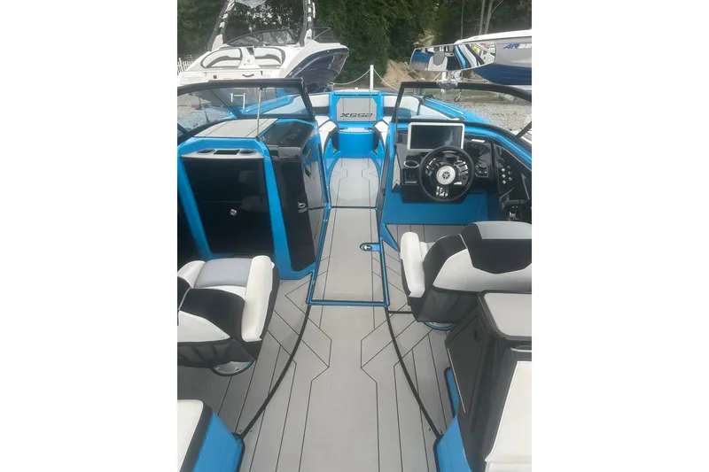 Slide: The Image of 2021 Yamaha Boats 255XE interior with modern dashboard and seating. - 2
