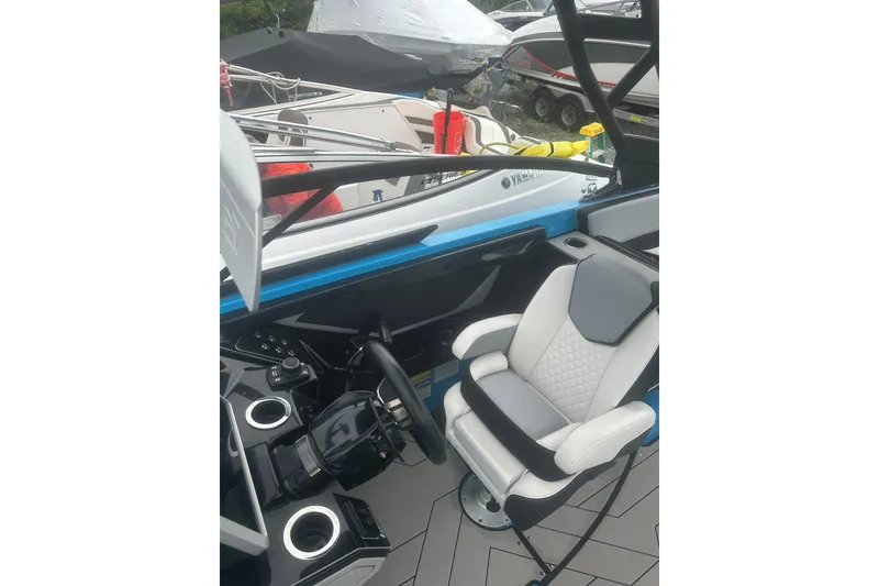 Slide: The Image of 2021 Yamaha Boats 255XE cockpit with modern steering and comfortable seating. - 13