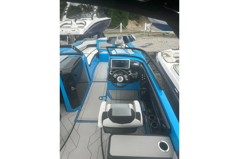 Slide: The Image of 2021 Yamaha Boats 255XE interior with modern dashboard and seating. - 9