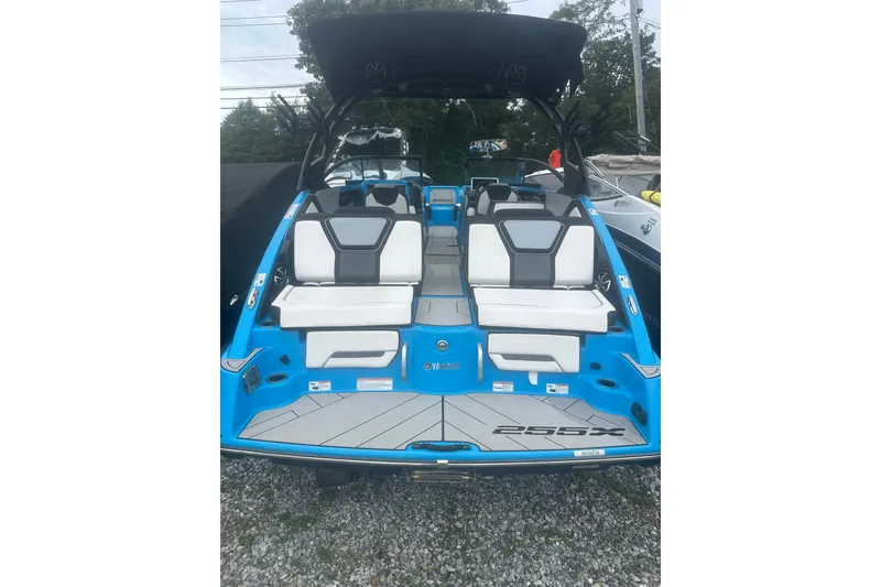 Slide: The Image of 2021 Yamaha Boats 255XE with sleek blue design and comfortable seating. - 4