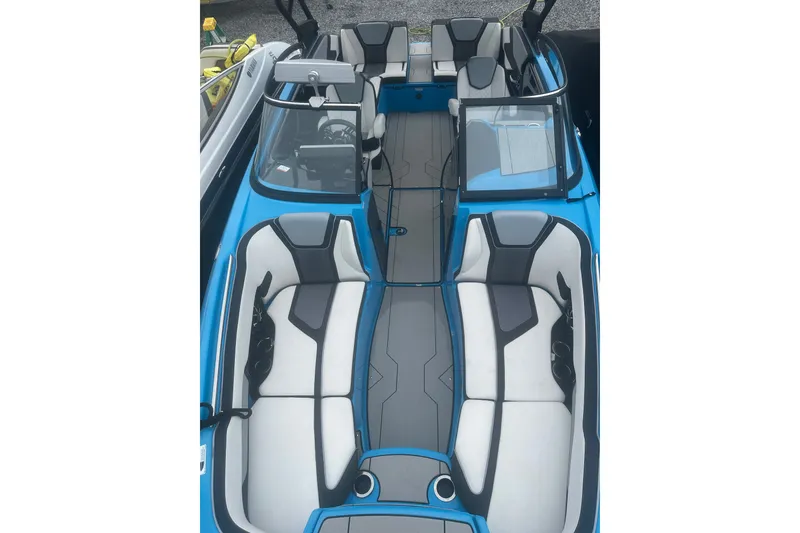 Slide: The Image of 2021 Yamaha Boats 255XE interior, featuring sleek blue and gray seating with modern design. - 16