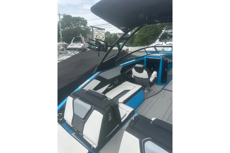 Slide: The Image of 2021 Yamaha Boats 255XE interior with modern seating and sleek design. - 11