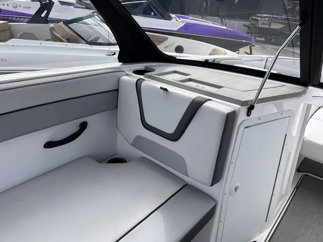 Slide: The Image of The image shows the interior of a 2024 Yamaha AR220 boat with white and gray upholstery. - 17