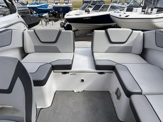 Slide: The Image of The image shows the interior of a 2024 Yamaha AR220 boat with gray upholstery. - 20