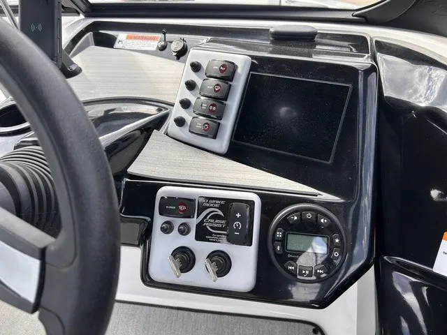 Slide: The Image of The image shows the dashboard of a 2024 Yamaha AR220 boat with modern controls. - 15