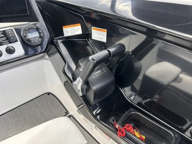 Slide: The Image of Close-up of a Yamaha AR220 boat's helm with throttle lever and instruments. - 16