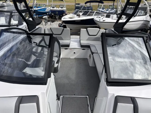 Slide: The Image of The image shows the cockpit of a 2024 Yamaha AR220 boat with gray and white seating. - 19