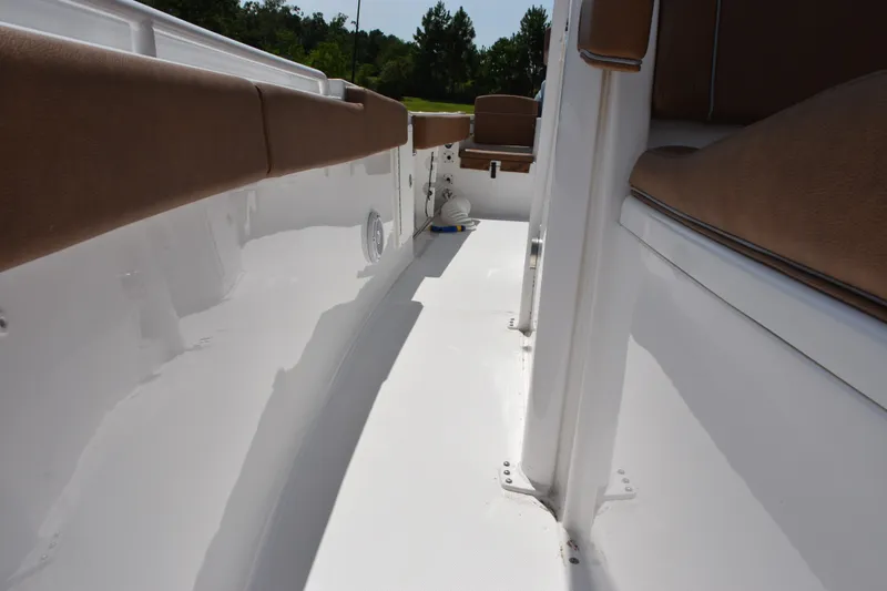 Slide: The Image of 2023 Sea Hunt Gamefish 27CB boat interior with brown seating and white deck. - 17