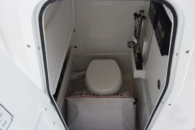 Slide: The Image of 2023 Sea Hunt Gamefish 27CB boat interior with compact marine toilet. - 18