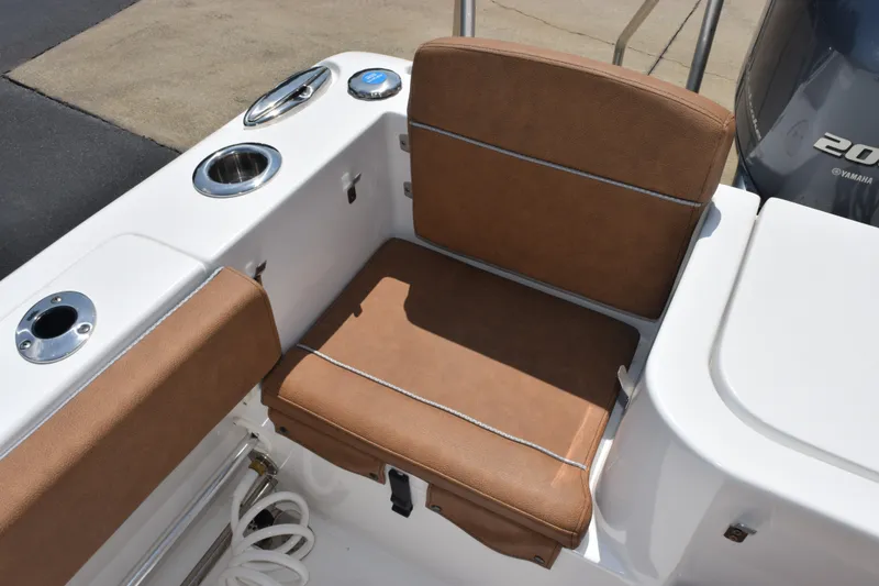 Slide: The Image of 2023 Sea Hunt Gamefish 27CB boat seating area with brown cushions and cup holders. - 26