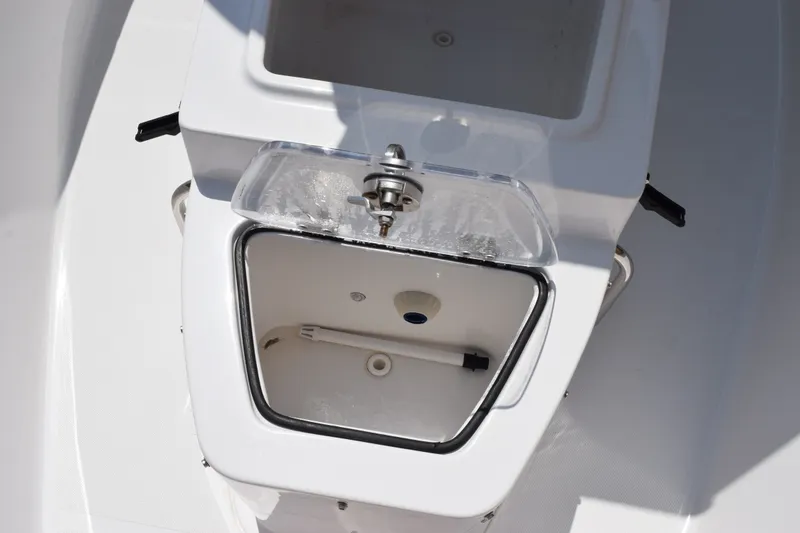 Slide: The Image of Livewell compartment on 2023 Sea Hunt Gamefish 27CB boat, featuring a clear lid and drain. - 23