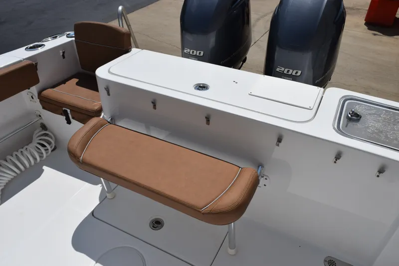 Slide: The Image of 2023 Sea Hunt Gamefish 27CB boat interior with brown seating and dual 200 engines. - 25