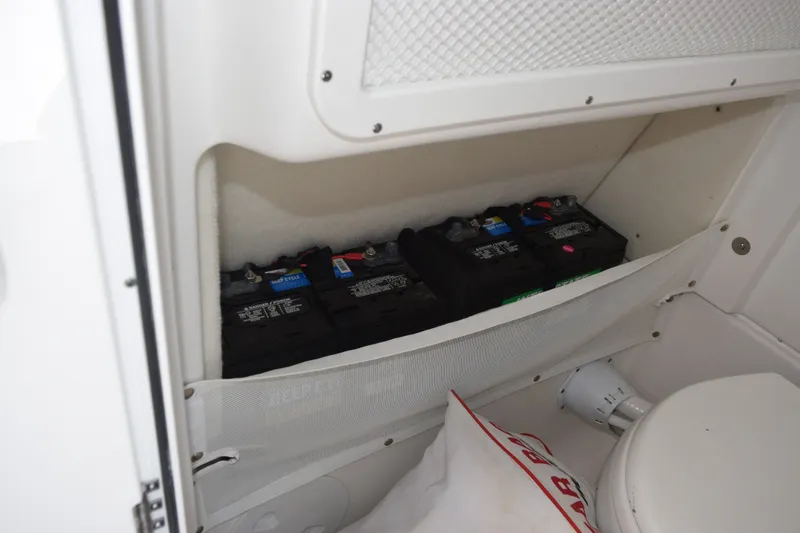 Slide: The Image of Battery compartment in 2023 Sea Hunt Gamefish 27CB boat, featuring multiple batteries. - 21