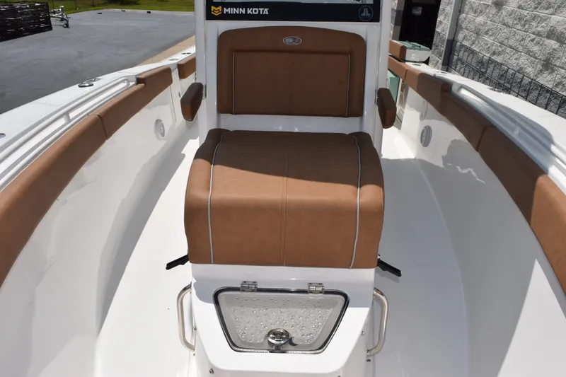 Slide: The Image of 2023 Sea Hunt Gamefish 27CB boat interior with brown seating and Minn Kota equipment. - 15
