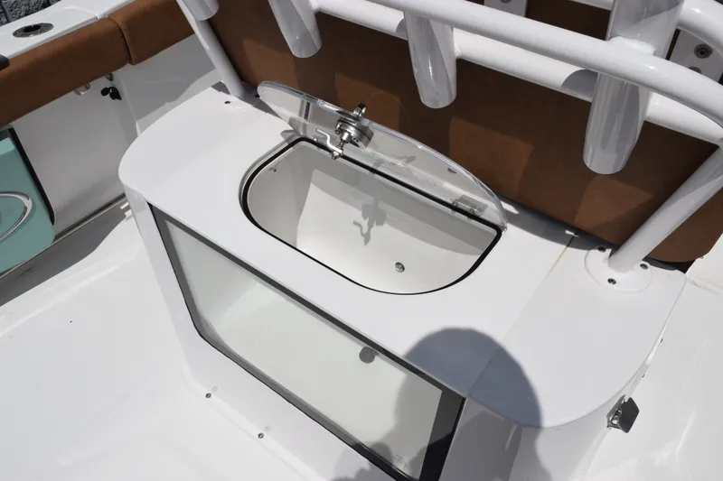Slide: The Image of 2023 Sea Hunt Gamefish 27CB boat with open storage compartment and rod holders. - 24