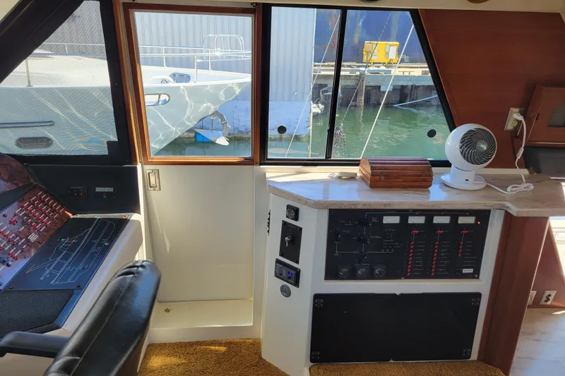 Slide: The Image of Interior view of 1991 Bayliner 4588 Pilothouse helm with control panels and window view. - 17