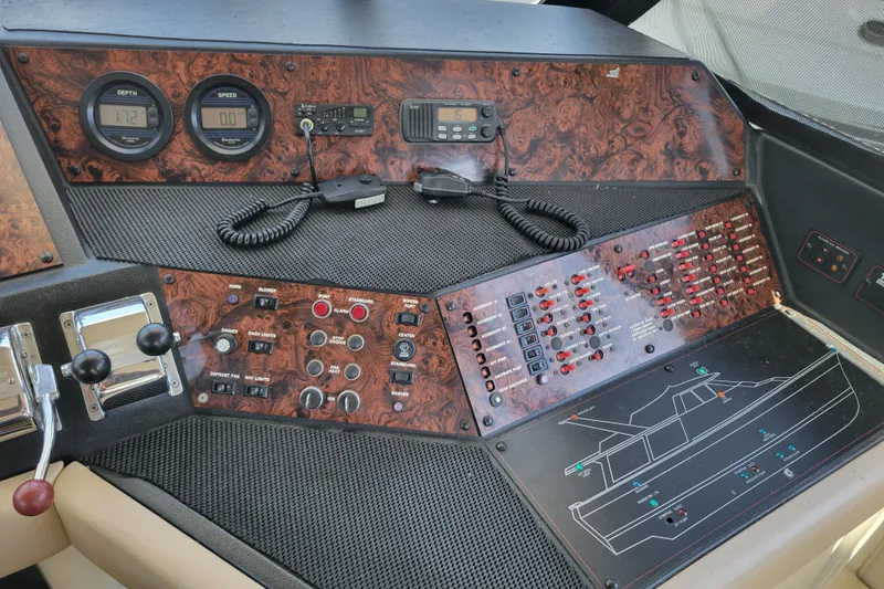Slide: The Image of 1991 Bayliner 4588 Pilothouse dashboard with controls, gauges, and navigation equipment. - 20
