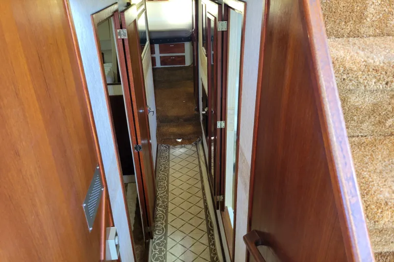 Slide: The Image of Interior hallway of 1991 Bayliner 4588 Pilothouse with wood paneling and carpeted stairs. - 25